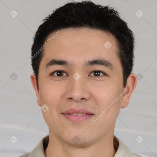 Joyful white young-adult male with short  black hair and brown eyes