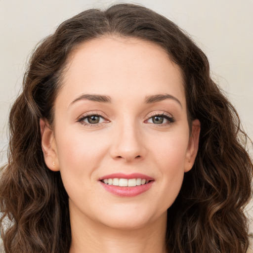 Joyful white young-adult female with long  brown hair and green eyes