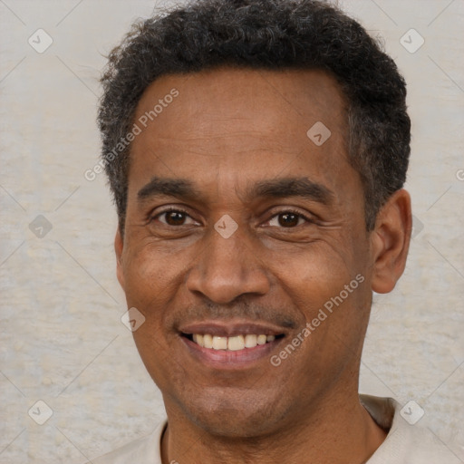 Joyful black adult male with short  brown hair and brown eyes