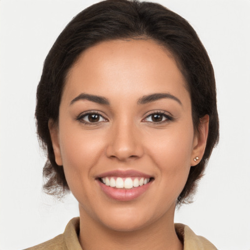 Joyful latino young-adult female with medium  brown hair and brown eyes