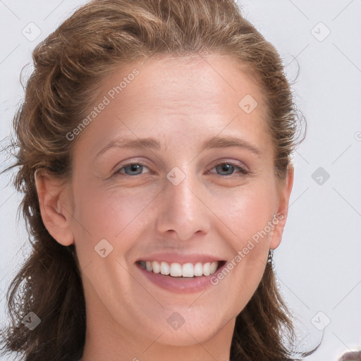 Joyful white young-adult female with long  brown hair and blue eyes