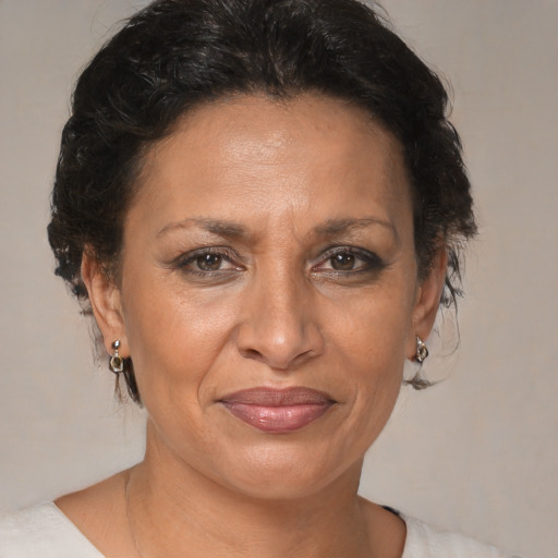 Joyful black adult female with medium  brown hair and brown eyes
