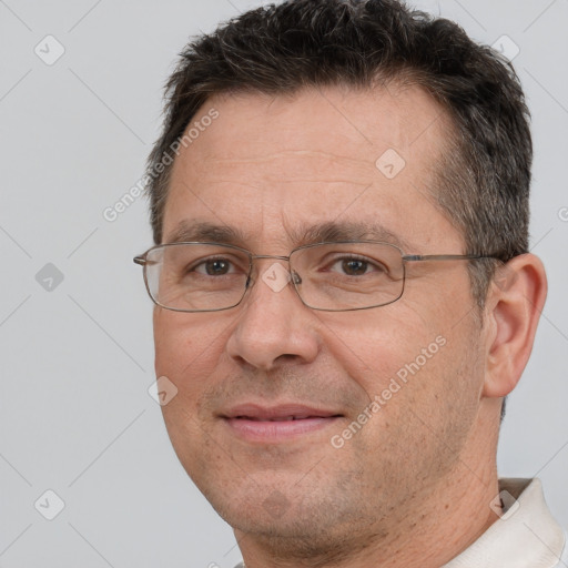 Joyful white adult male with short  brown hair and brown eyes