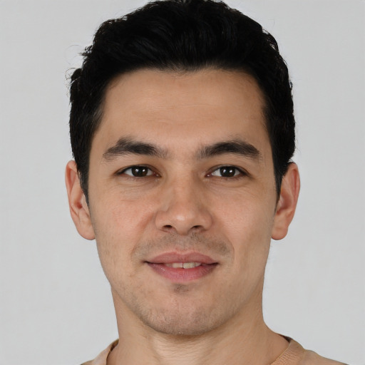 Joyful latino young-adult male with short  black hair and brown eyes