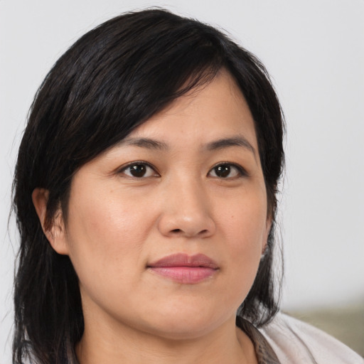 Joyful asian young-adult female with medium  black hair and brown eyes