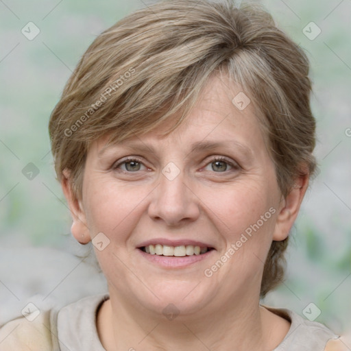 Joyful white adult female with medium  brown hair and grey eyes