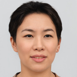 Joyful asian young-adult female with short  brown hair and brown eyes