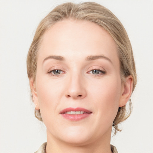 Joyful white young-adult female with medium  brown hair and blue eyes