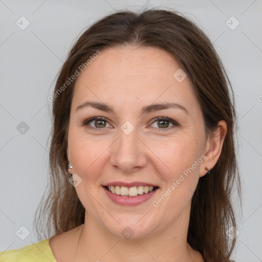 Joyful white adult female with medium  brown hair and brown eyes