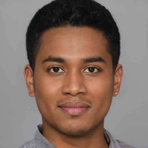 Joyful black young-adult male with short  black hair and brown eyes