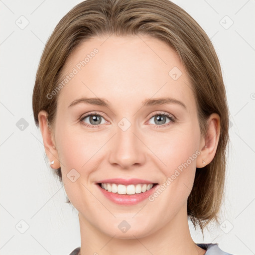 Joyful white young-adult female with medium  brown hair and blue eyes