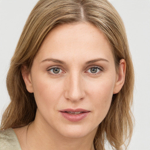 Joyful white young-adult female with medium  brown hair and blue eyes