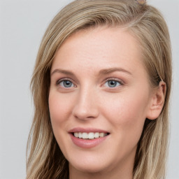 Joyful white young-adult female with long  brown hair and blue eyes