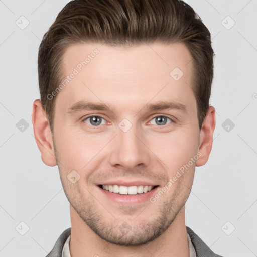 Joyful white young-adult male with short  brown hair and grey eyes