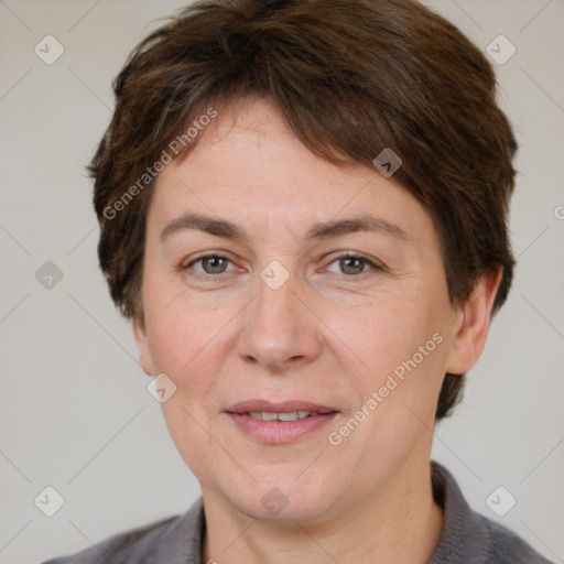 Joyful white adult female with short  brown hair and grey eyes