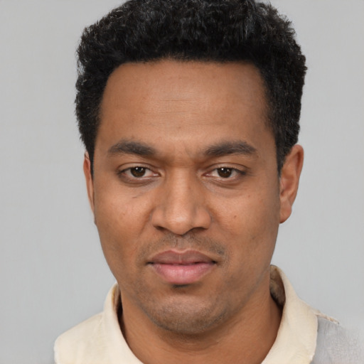 Neutral latino young-adult male with short  black hair and brown eyes