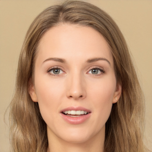 Joyful white young-adult female with long  brown hair and green eyes