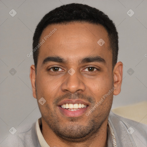 Joyful black young-adult male with short  black hair and brown eyes