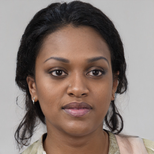 Joyful black young-adult female with medium  brown hair and brown eyes