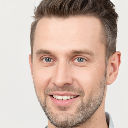 Joyful white adult male with short  brown hair and brown eyes