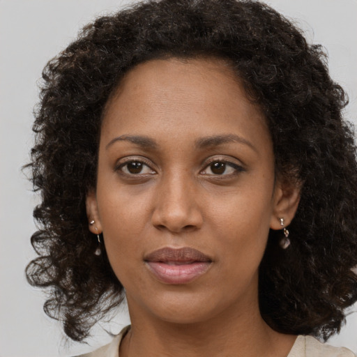 Neutral black young-adult female with medium  brown hair and brown eyes
