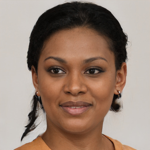 Joyful black young-adult female with short  black hair and brown eyes