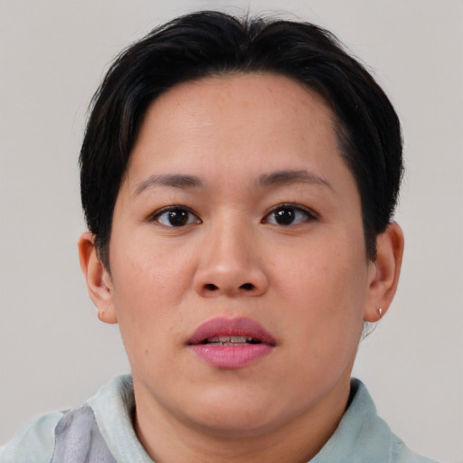 Joyful asian young-adult female with short  brown hair and brown eyes