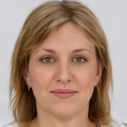 Joyful white adult female with medium  brown hair and grey eyes