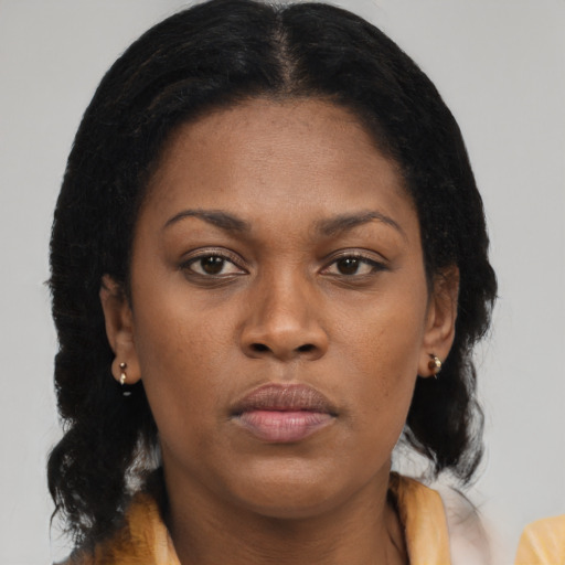 Joyful black young-adult female with medium  brown hair and brown eyes