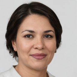 Joyful white adult female with medium  brown hair and brown eyes