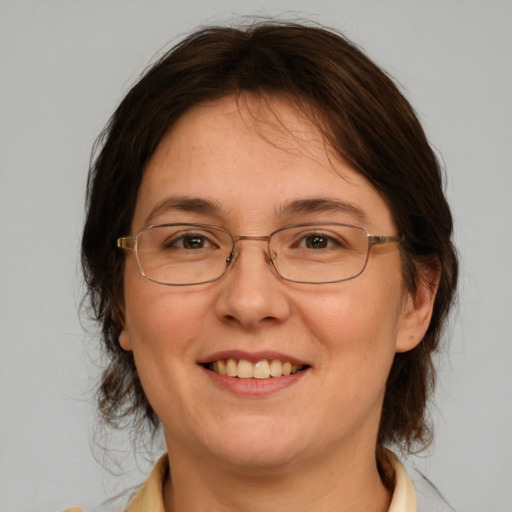 Joyful white adult female with medium  brown hair and brown eyes