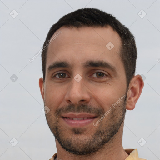 Joyful white young-adult male with short  black hair and brown eyes