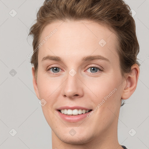 Joyful white young-adult female with short  brown hair and grey eyes