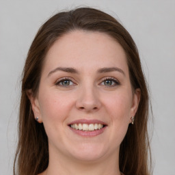 Joyful white young-adult female with long  brown hair and grey eyes