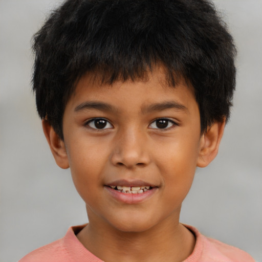 Joyful latino child male with short  brown hair and brown eyes
