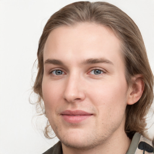 Joyful white young-adult male with medium  brown hair and grey eyes