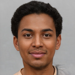 Joyful latino young-adult male with short  brown hair and brown eyes