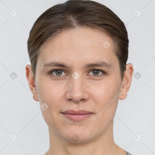 Joyful white young-adult female with short  brown hair and grey eyes