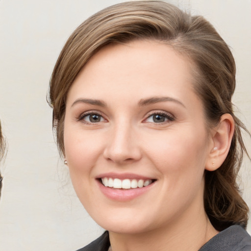 Joyful white young-adult female with medium  brown hair and grey eyes