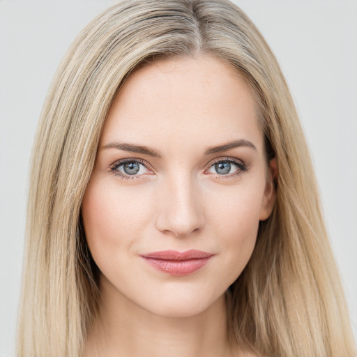 Joyful white young-adult female with long  brown hair and blue eyes