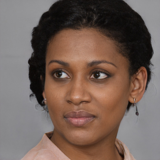 Joyful black young-adult female with short  brown hair and brown eyes