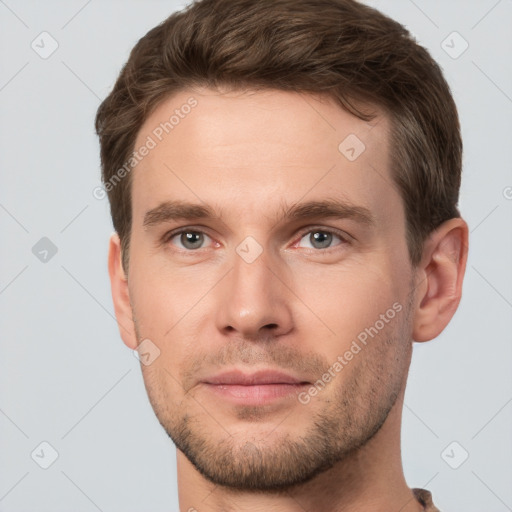 Joyful white young-adult male with short  brown hair and grey eyes