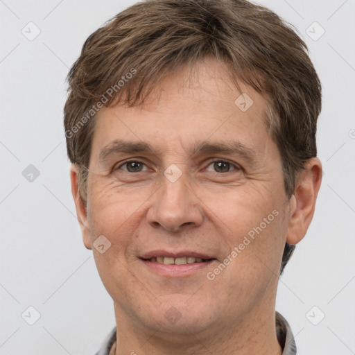 Joyful white adult male with short  brown hair and grey eyes