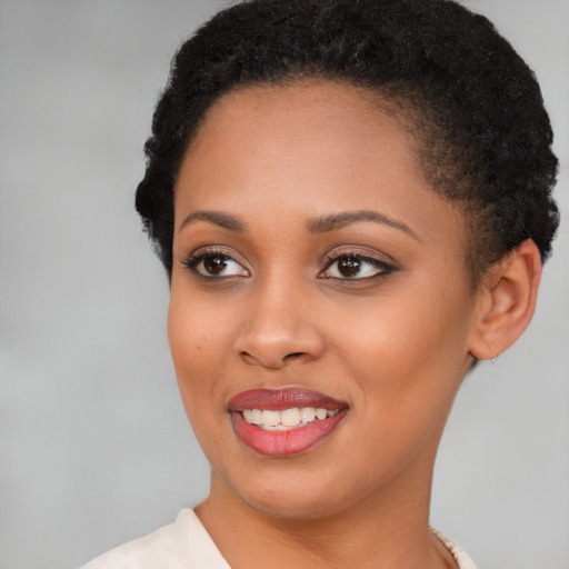 Joyful black young-adult female with short  brown hair and brown eyes