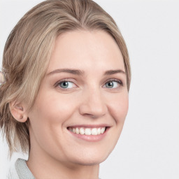 Joyful white young-adult female with medium  brown hair and blue eyes