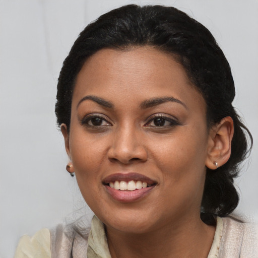 Joyful black young-adult female with medium  black hair and brown eyes