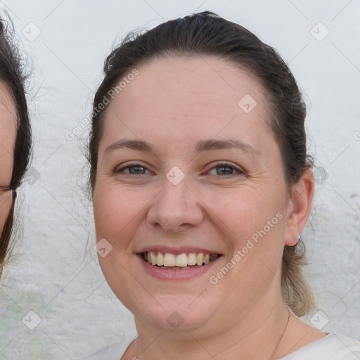 Joyful white adult female with medium  brown hair and brown eyes