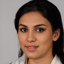 Joyful latino young-adult female with medium  brown hair and brown eyes