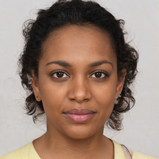 Joyful black young-adult female with medium  brown hair and brown eyes