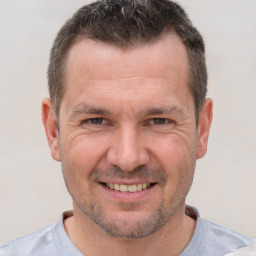 Joyful white adult male with short  brown hair and brown eyes